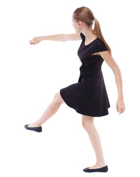 skinny woman funny fights waving his arms and legs. Blonde in a short black dress kicking ball