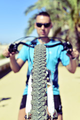 young man doing a wheelie with his bicycle