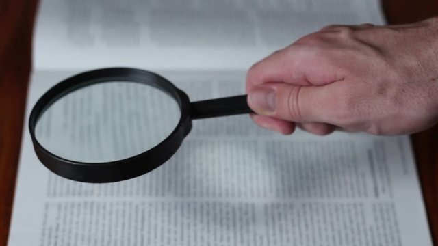 Looking through the magazine with magnifying lens