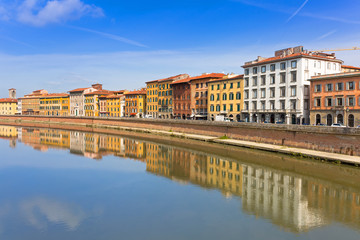 Fototapeta na wymiar Old town of Pisa with reflection in Arno river, Italy