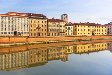Fototapeta na wymiar Old town of Pisa with reflection in Arno river, Italy