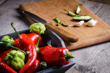 Colored pepper and garlic on cutting board.