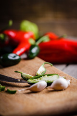 Colored pepper and garlic on cutting board.