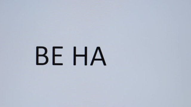 Somebody prints "Be happy" on a computer