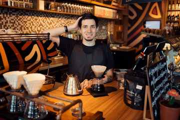 Fototapeta na wymiar Barista at work in a coffee shop