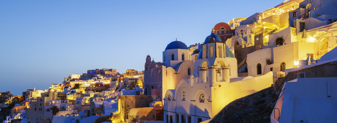 Panoramic view of Oia village at night
