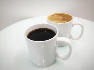 Cappuccino and black coffee in mug white black ground