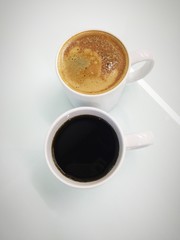 Cappuccino and black coffee in mug white black ground
