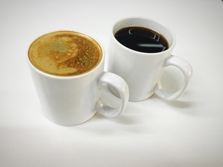 Cappuccino and black coffee in mug white black ground