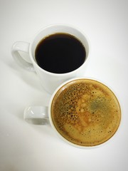 Cappuccino and black coffee in mug white black ground