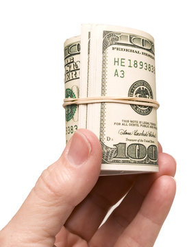 Hand Holding Roll Of Cash/ Vertical shot of hand holding a large roll of cash with rubber band