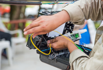 Technicians are install cabinet on fiber optic cable.Blur images