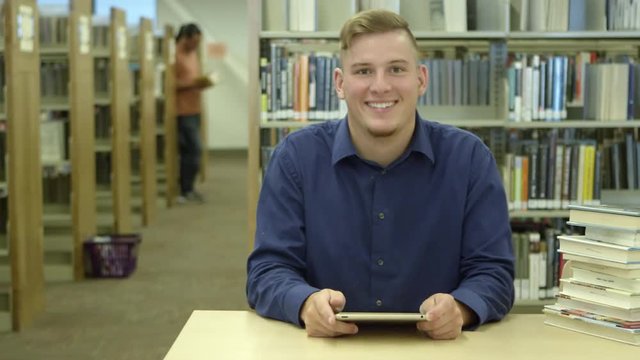 Man using tablet in library