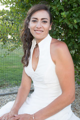 Woman with long ark hair wearing classic white top