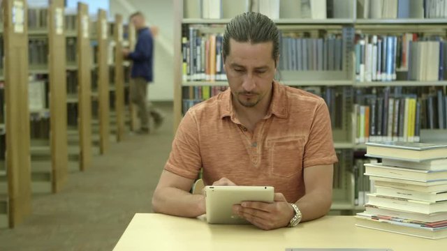 Man using tablet in library
