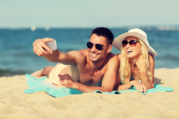 Fototapeta premium happy couple in swimwear walking on summer beach