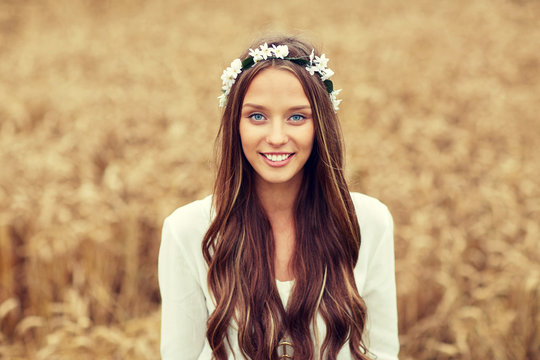 smiling young hippie woman on cereal field