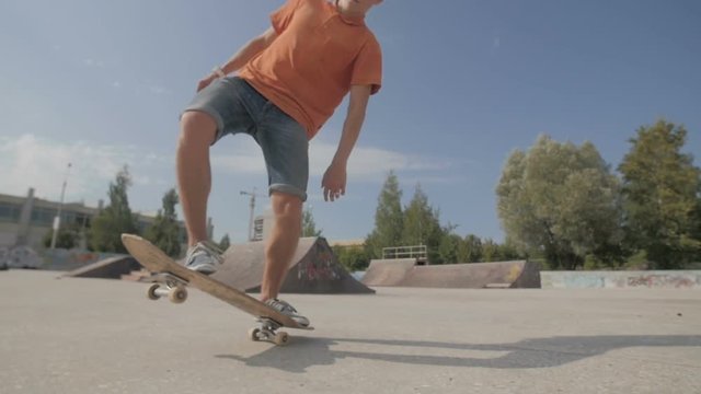 Unrecognizable young man skateboarding. Close-up. SLOW MOTION. HD