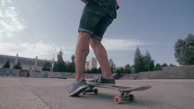 Unrecognizable young man skateboarding. Close-up. SLOW MOTION. HD