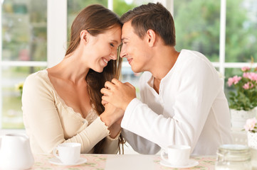Couple with cups of tea in the kitchen