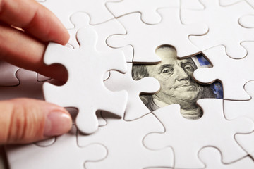 Collecting dollar banknote with jigsaw puzzle