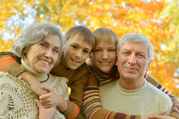 Fototapeta premium Grandparents with children in park