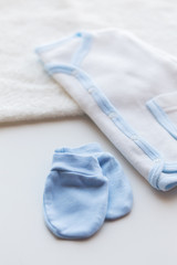 close up of baby boys clothes for newborn on table