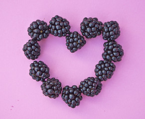 Blackberries in Heart Shape on Pink Background