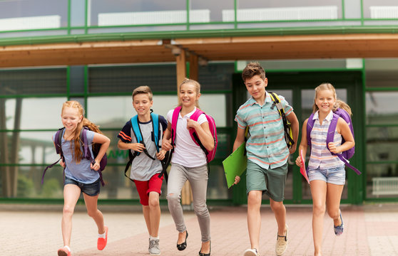 Group Of Happy Elementary School Students Running