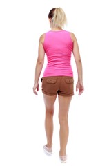 back view of walking woman. beautiful blonde girl in motion. Isolated over white background. Sport blond in brown shorts takes a step forward.
