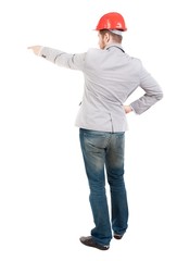 Back view of pointing young men in helmet. guy in a gray jacket and an orange helmet showing thumb up.