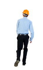 Back view of running engineer in helmet. Businessman in a blue shirt and a helmet runs into the interior of the frame.