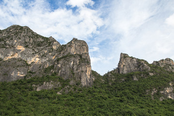 Fototapeta na wymiar Beautiful calcite mountain with blue sky at khao sam roi yod nat