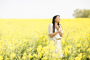 Fototapeta premium Young woman in the spring field