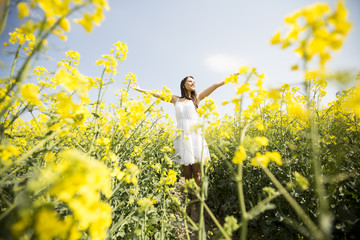 Fototapeta premium Young woman in the spring field