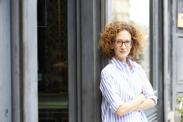 The best shop in town. Portrait of a happy young woman standing in the doorway of her store. Small business.