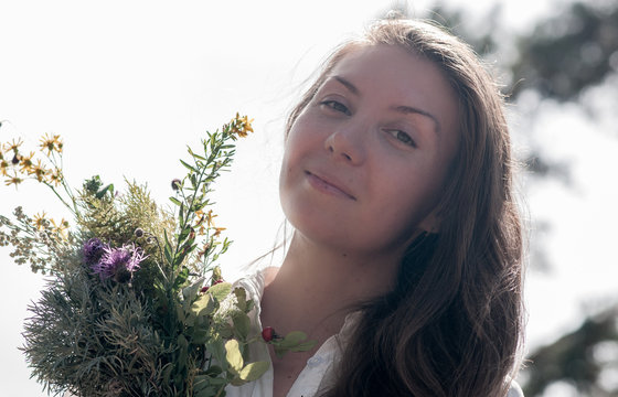 girl with a wreath of flowers in nature