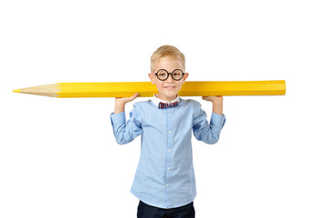 Happy boy in glasses and bowtie posing with a huge pencil. Educational concept. Isolated over white.