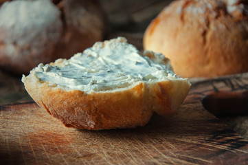 Sandwiches with cream cheese with chives wooden background.