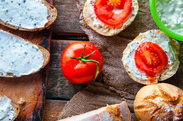 Sandwiches with cream cheese with chives wooden background. from