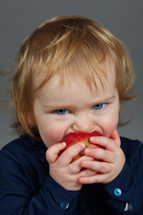 little girl eating an apple