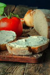 Sandwiches with cream cheese with chives wooden background.