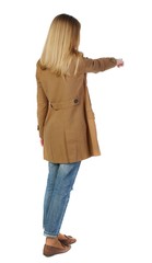 Back view of pointing young women in parka. blonde in a brown cloak, points a finger forward.