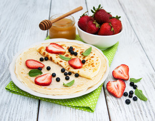 Fototapeta na wymiar crepes with strawberries and blueberries