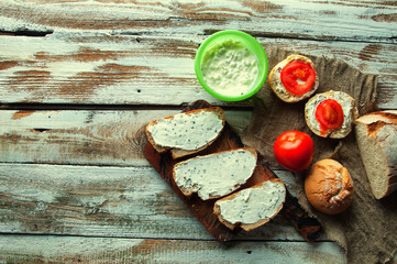Sandwiches with cream cheese with chives wooden white background