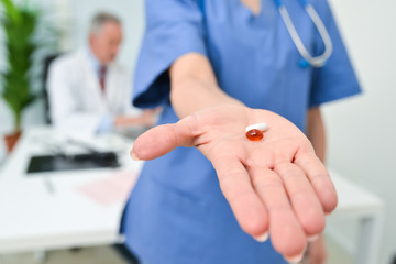 Obraz na płótnie Canvas Nurse giving pills to a patient