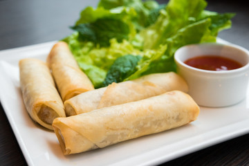 Spring rolls served with dipping sauce