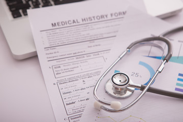 Medical concept with stethoscope on medical history form