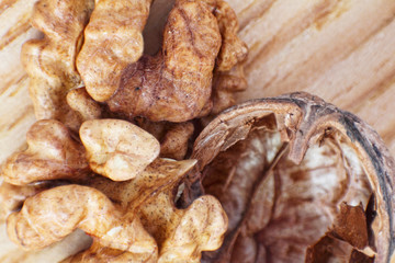 Walnut and nutshell taken closeup on table.