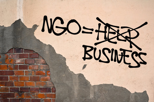Ngo is Business - Handwritten graffiti sprayed on wall, anarchist aesthetics - Critique of Non-governmental organizations - lack of transparency, scandal with funding and donating